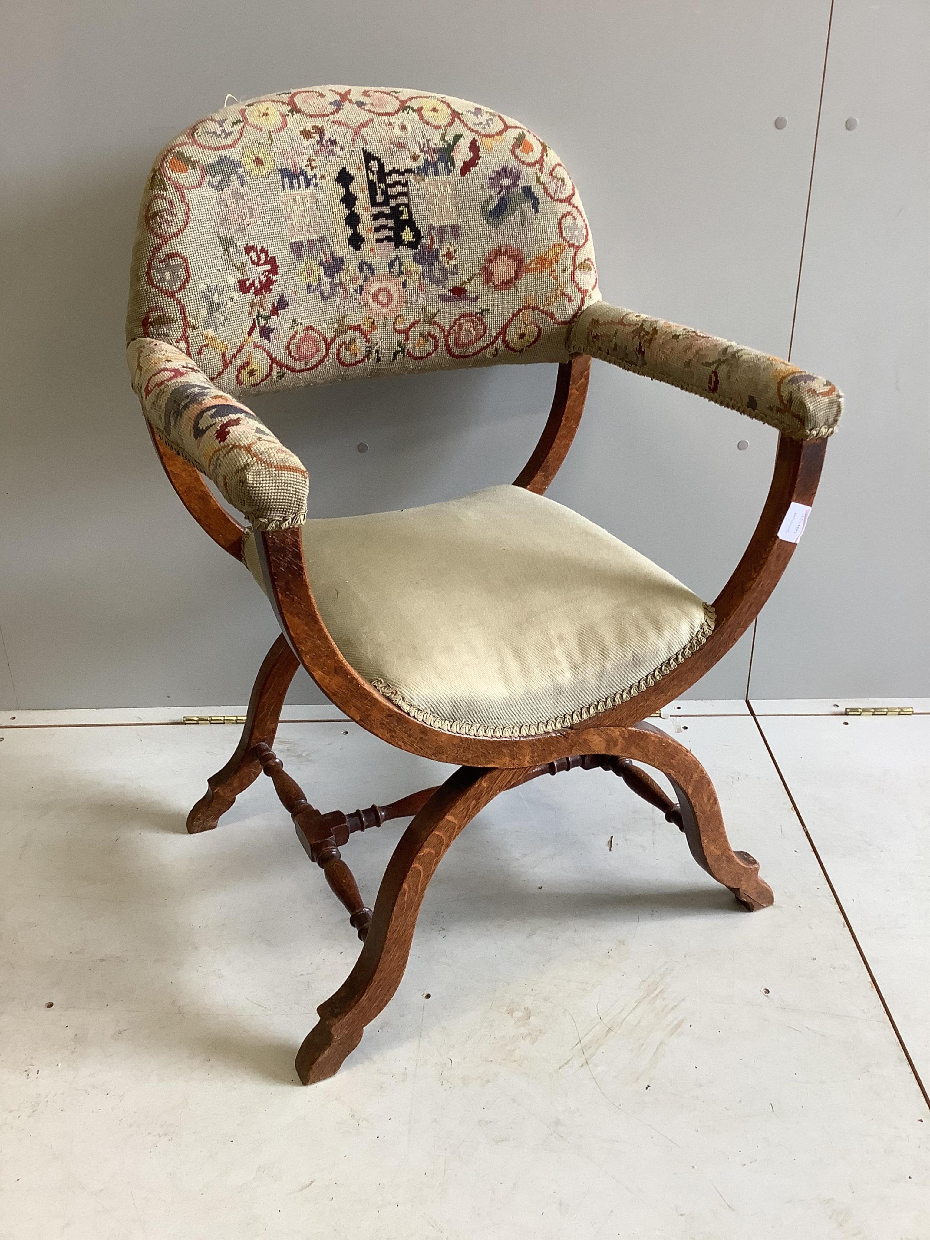An early 20th century upholstered oak Savonarola style armchair, width 64cm, depth 53cm, height 96cm. Condition - fair